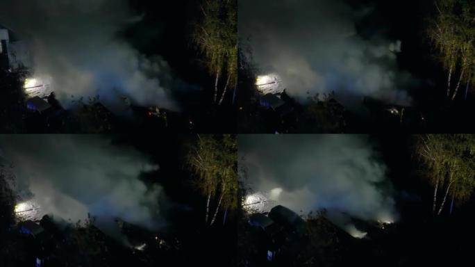 一组消防员灭火的无人机飞行视点。在黑烟中寻找幸存者