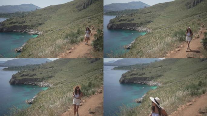 年轻女子在海边自然保护区的悬崖边徒步旅行