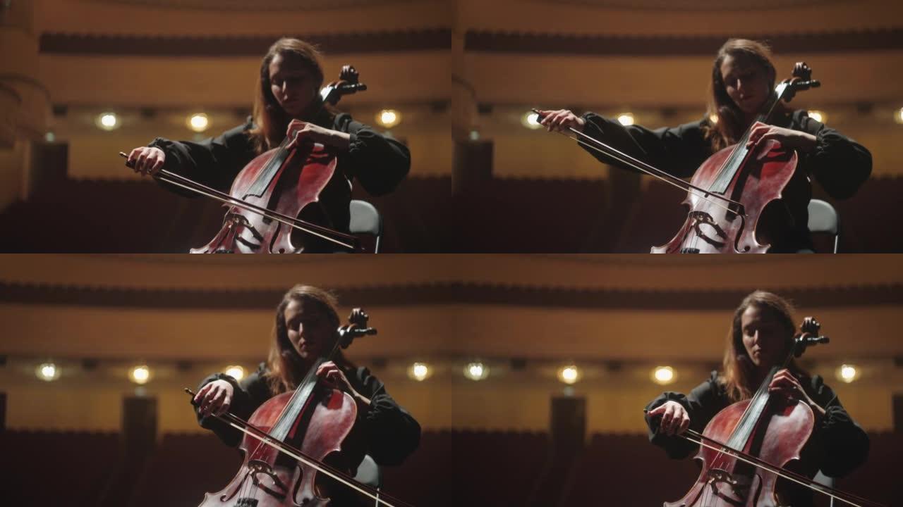 美女在音乐厅演奏大提琴，歌剧院现场的女小提琴演奏家