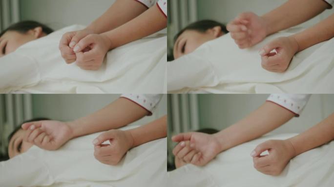 女人手作为泰国按摩治疗师按摩背部，预防背部疼痛。