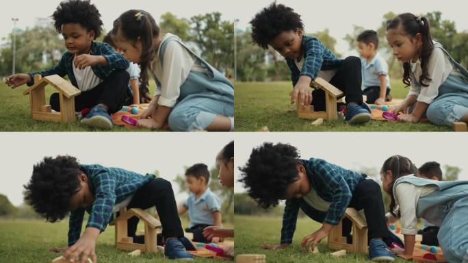 儿童团体在户外玩木制玩具。