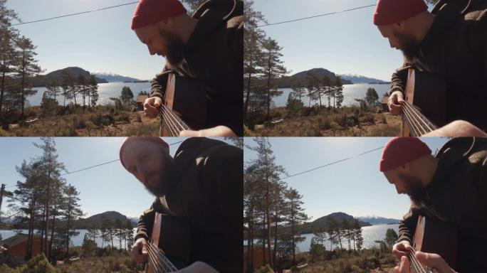 男子在度假小屋的户外演奏原声吉他