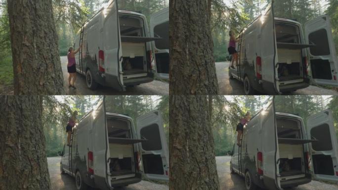 荒野中一名妇女和一辆露营货车的详细照片