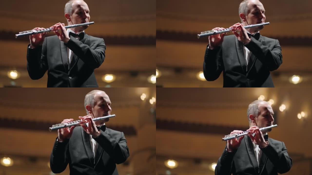 才华横溢的长笛演奏家正在用长笛演奏新古典音乐，这是爱乐音乐厅的音乐家肖像