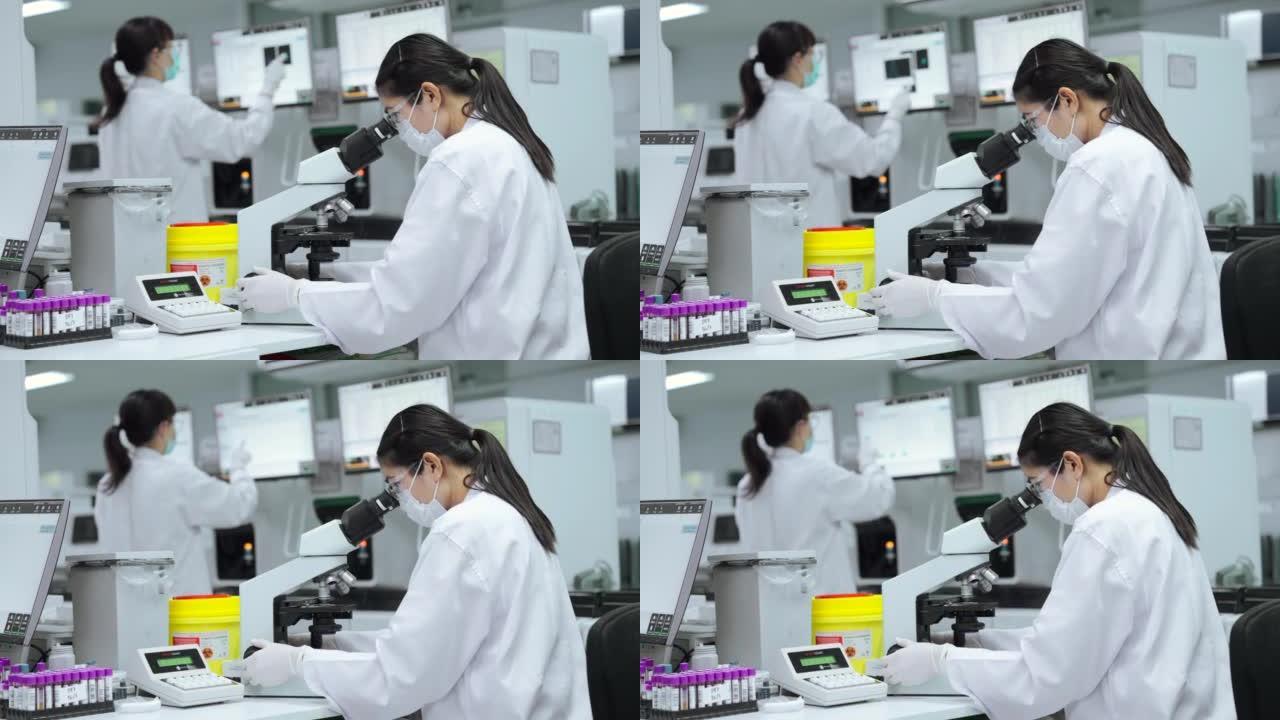 医疗技术人员使用先进的技术实验室设备检查患者的血液。