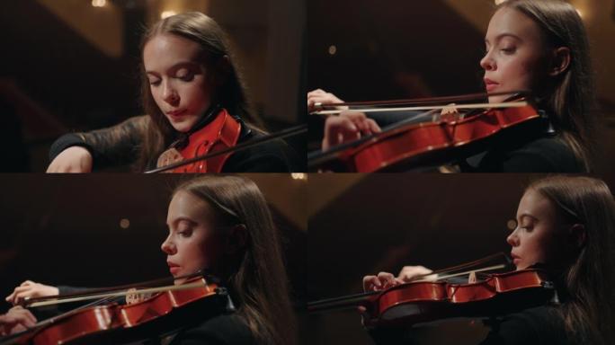 交响乐团年轻漂亮的女小提琴手，女人在音乐厅拉小提琴