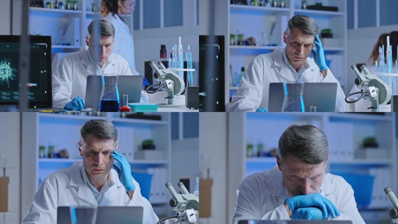 困惑的医学实验室科学家检查计算机上的病毒研究进展