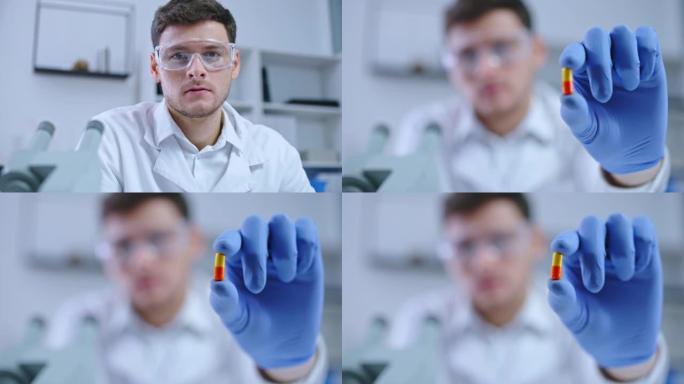 医学实验室研究人员在相机上展示药丸，治疗不治之症的药物
