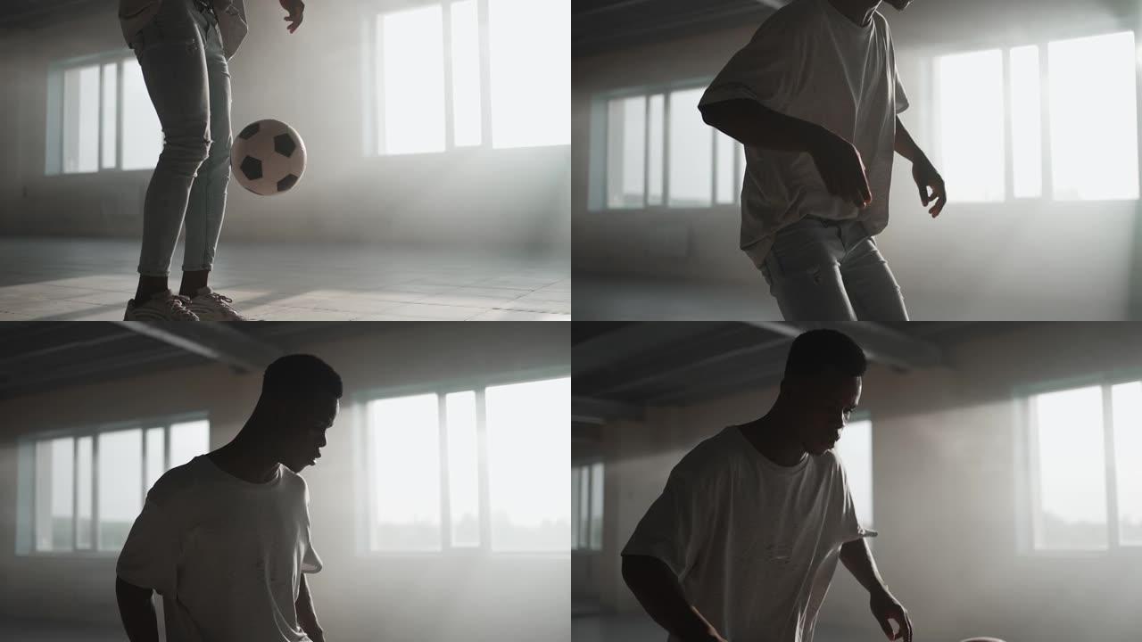 一个黑人在慢动作的阳光下在地下停车场里用足球训练。玩弄球，训练传球和踢球。努力取得成功
