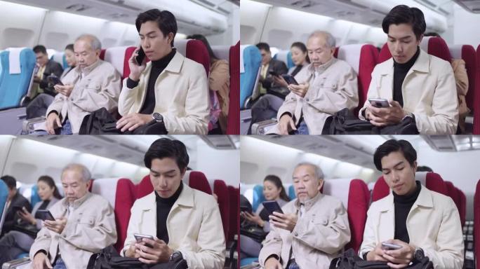 男子使用手机乘飞机旅行