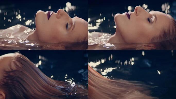水下冥想。诱人的女人享受感性的照明水，享受湿头发上干净的水