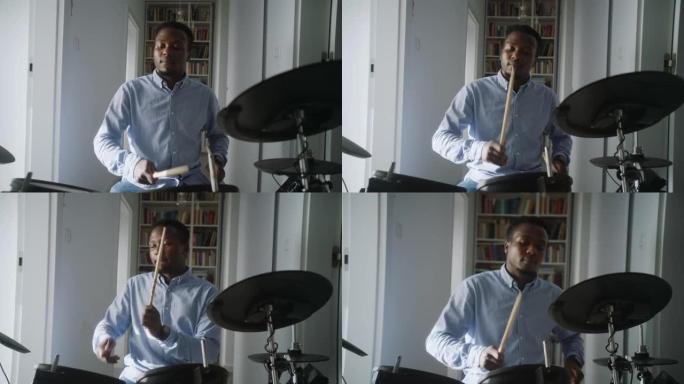 非洲人在客厅里练习电子鼓。前视图