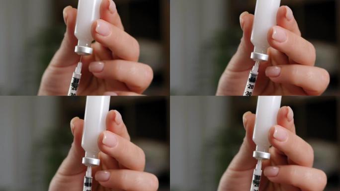 患有糖尿病的妇女用注射器和胰岛素在手边特写。