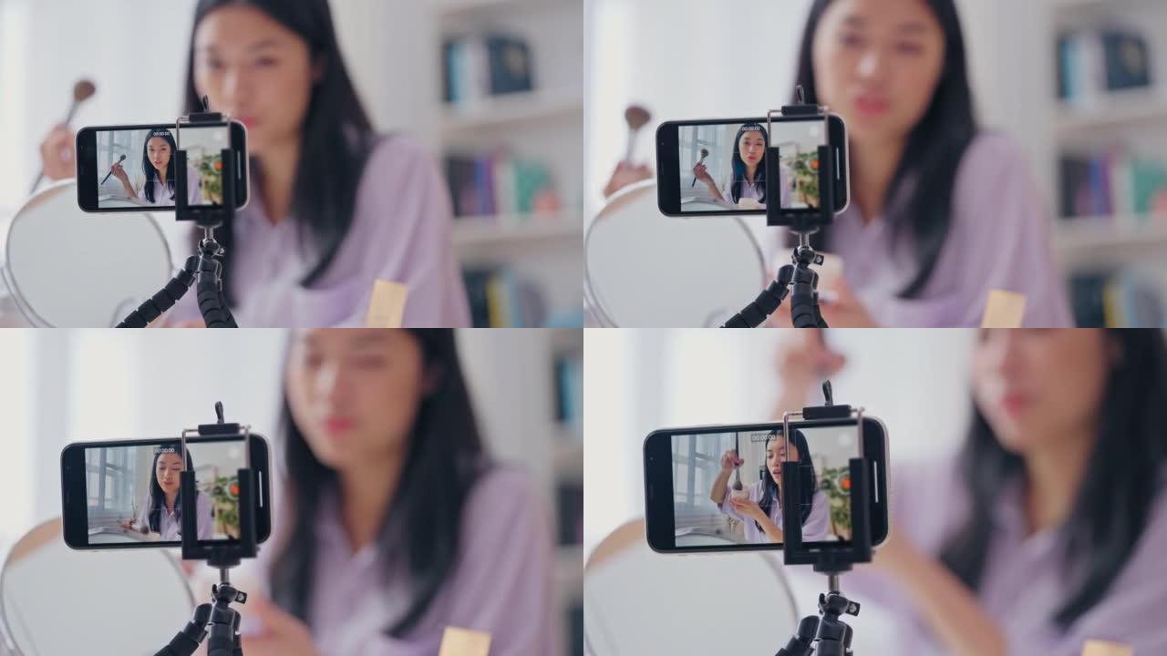 亚洲美容博主在智能手机相机上化妆，测试化妆品