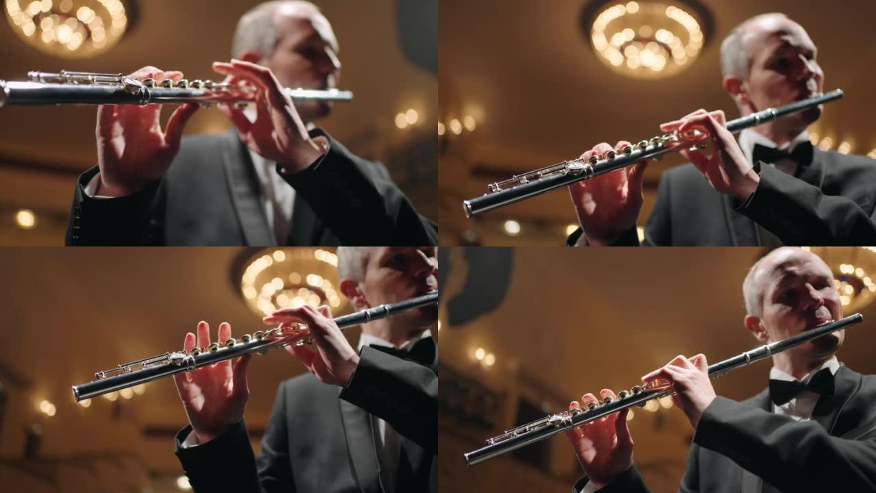 才华横溢的长笛演奏家正在老歌剧院或爱乐音乐厅演奏长笛，音乐家的肖像