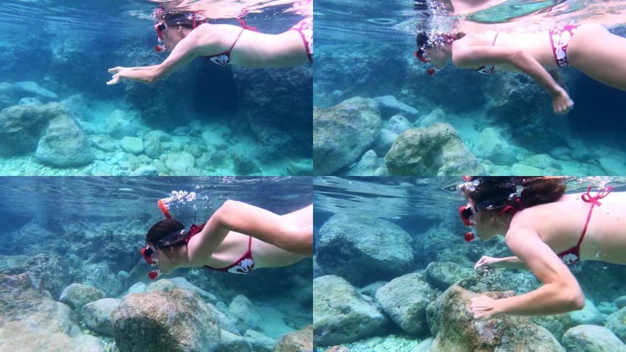 女人在海里浮潜。向可穿戴相机游泳