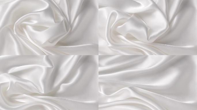白色布缎。抽象背景豪华布或液波。丝绸纹理材料。抽象白色优雅壁纸设计