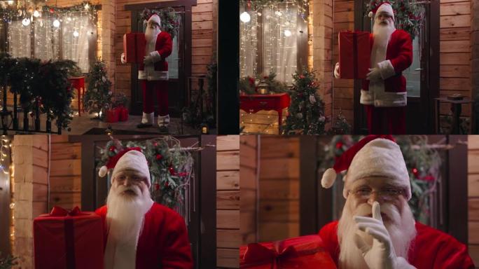 变焦相机圣诞老人冬天带着礼物站在户外的房子外面，看着相机