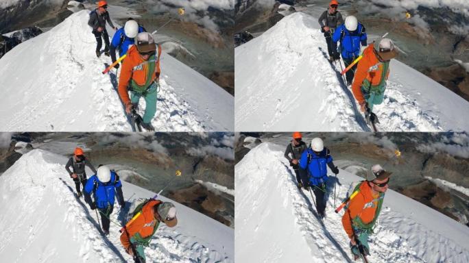 一队登山者沿着欧洲阿尔卑斯山的冰盖斜坡移动。使用绳索和攀爬设备
