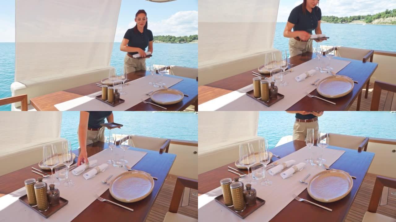 一艘准备餐桌的游艇上的SLO MO DS空姐