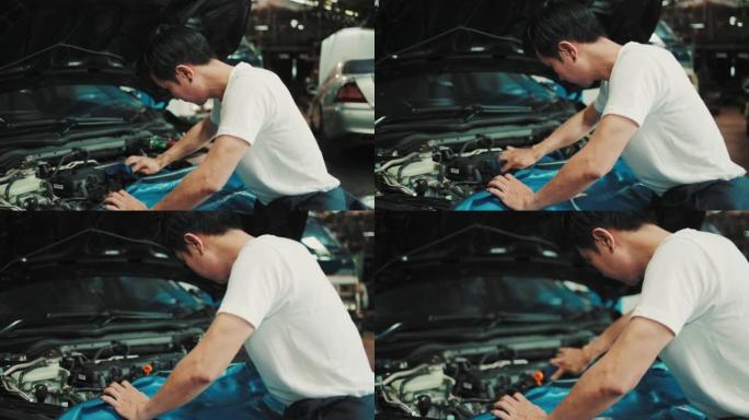 机械师在汽车修理厂检查汽车发动机