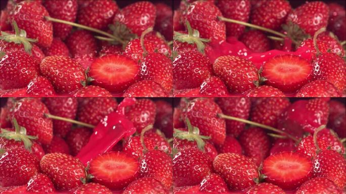 草莓落在草莓之间的果汁中。慢动作1000 fps
