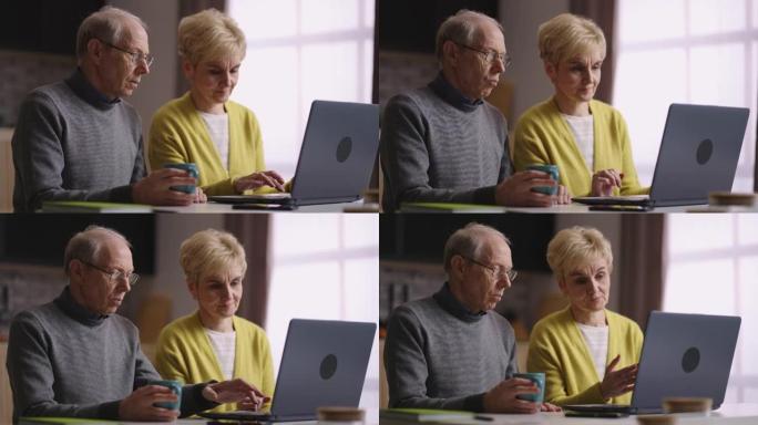 老年配偶一起使用笔记本电脑，周末坐在家里的厨房里，在线购物或在社交网络中交流