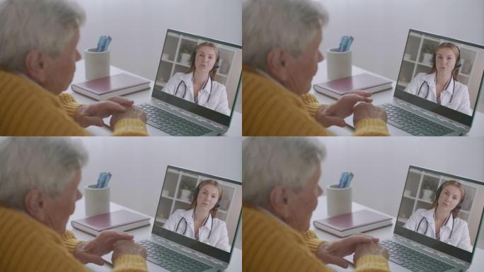 年轻的女医生正在通过视频通话咨询老人，老年人正在笔记本屏幕上听和看医生