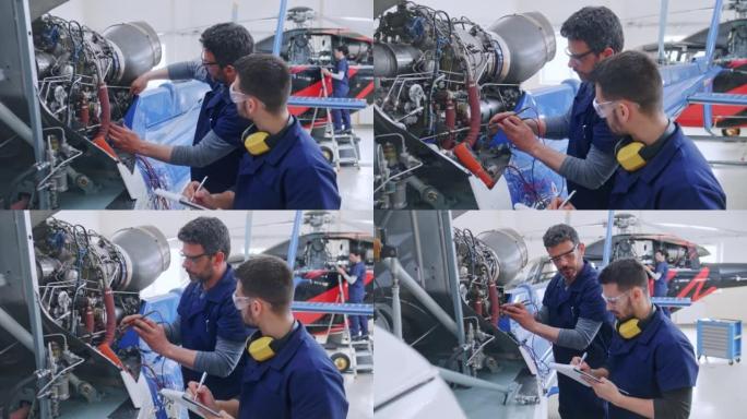 DS高级航空机械师在直升机发动机上工作时教他的学徒