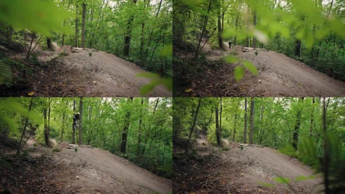 摄像机在手推车上移动，这是一名专业自行车手在山地自行车上高速跳过桥梁障碍物并在绿色森林中跳跃的电影拍