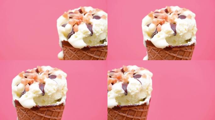 在粉红色背景上关闭的香草味冰淇淋蛋卷
