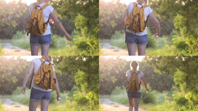 徒步旅行的妇女使用驱蚊剂防蚊和蜱。户外护肤