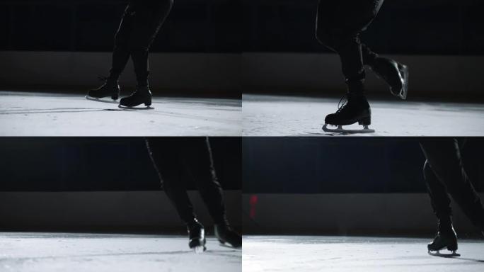 男花样滑冰运动员正在训练或表演比赛节目，在脚踩溜冰鞋上的特写镜头