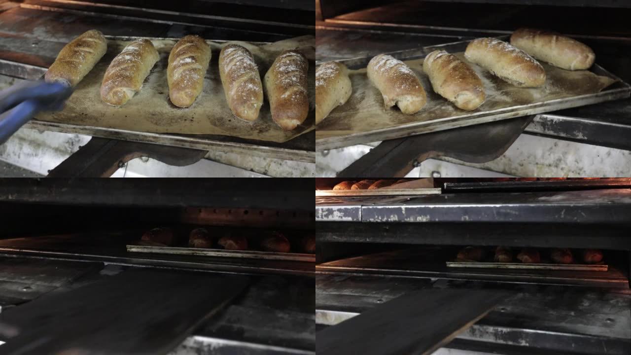 面包师从烤箱中拉出装有烤面包的托盘