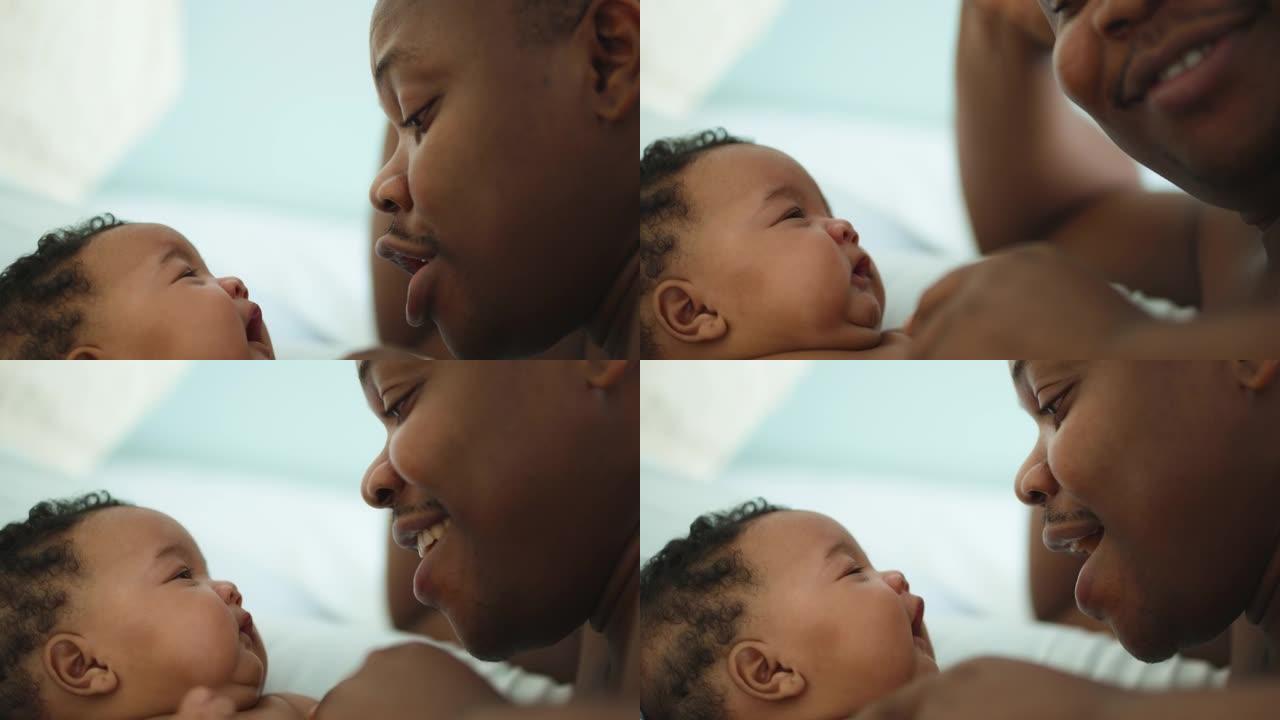 快乐的非洲父亲种族安慰他刚出生的女婴