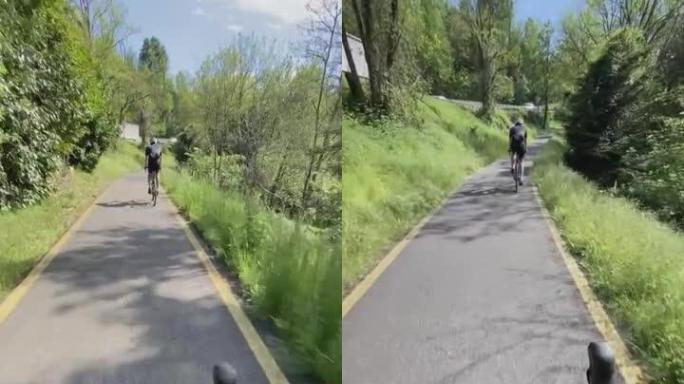 骑车人在高速公路附近的一条小路上骑行的镜头