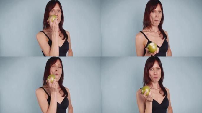 快乐的女人吃新鲜的青苹果