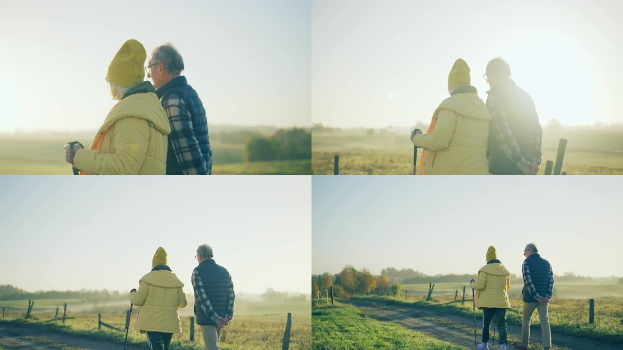 一对在乡下散步的老年夫妇。北欧步行健康