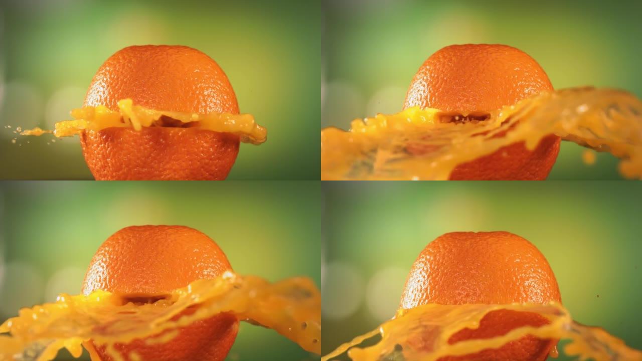 新鲜橙色水果在绿色自然背景4K慢动作中喷出并爆裂果汁