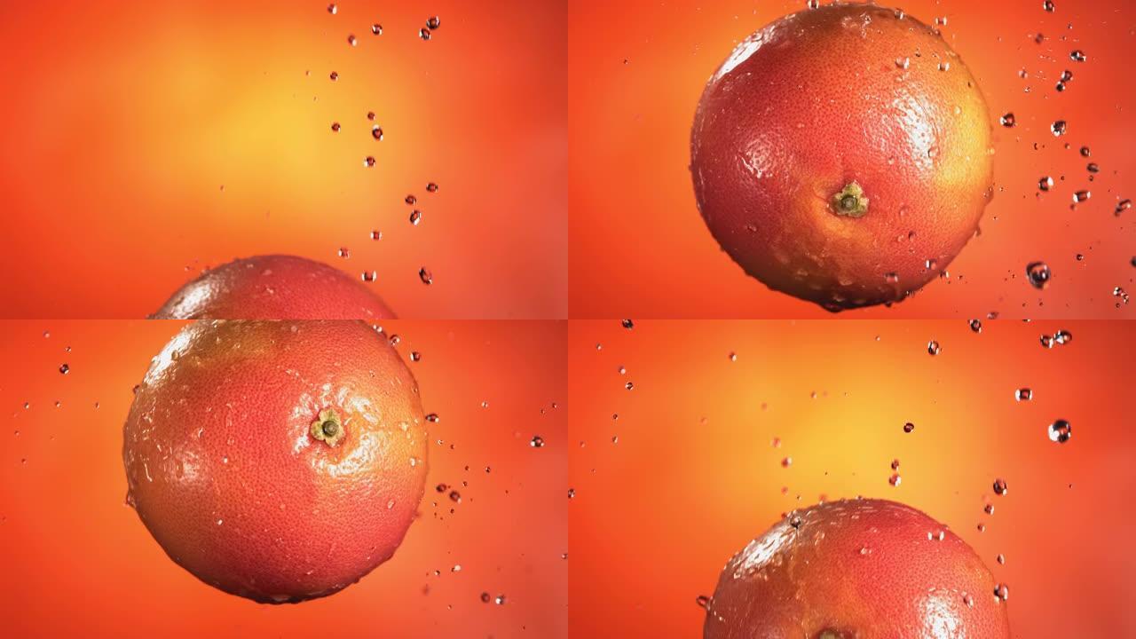 橙色背景下的葡萄柚在慢动作中的飞行