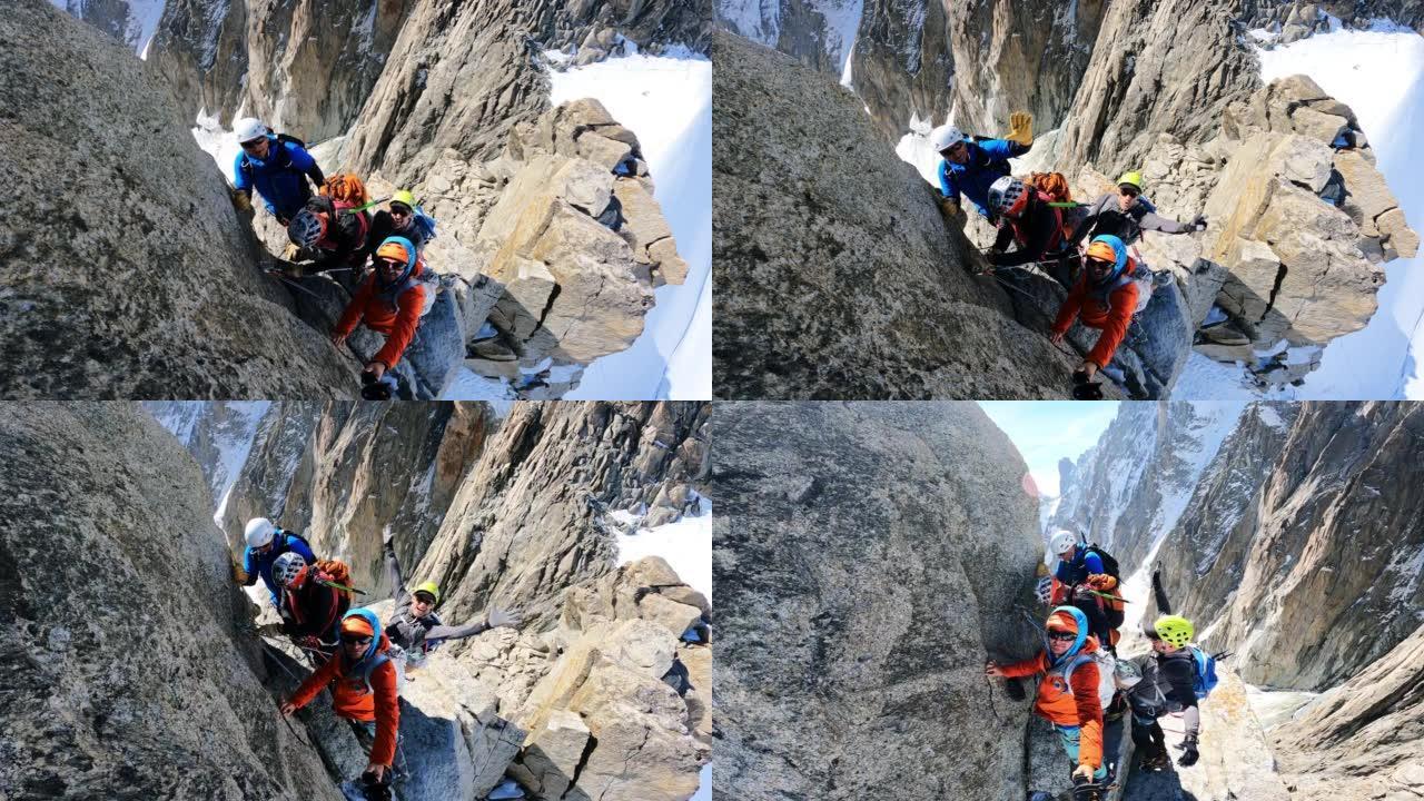 一队登山者在陡峭的山峰上移动。使用绳索和攀爬设备。欧洲阿尔卑斯山