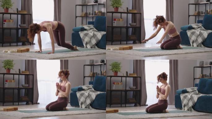 女人早上在公寓的客厅里做哈塔瑜伽练习，在公寓里拍摄全长照片