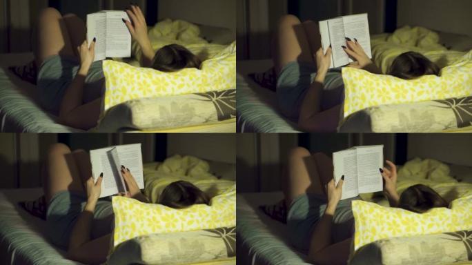 一个女孩躺在床上看书，光线昏暗