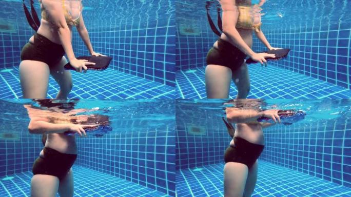 活跃的孕妇在水下锻炼。
