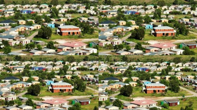 工人殖民地小型简易房屋的滑动和平移镜头。郊区的一组类似的低矮建筑。南非