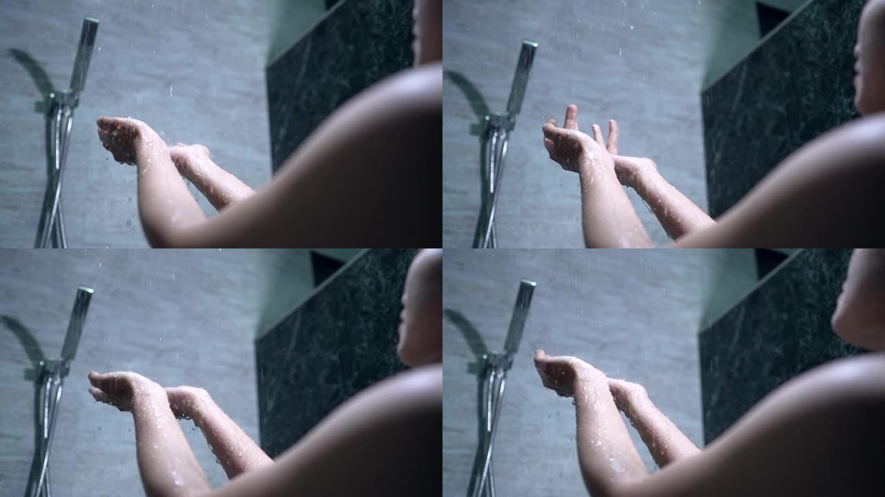 亚洲女孩她正在雨滴淋浴中洗澡