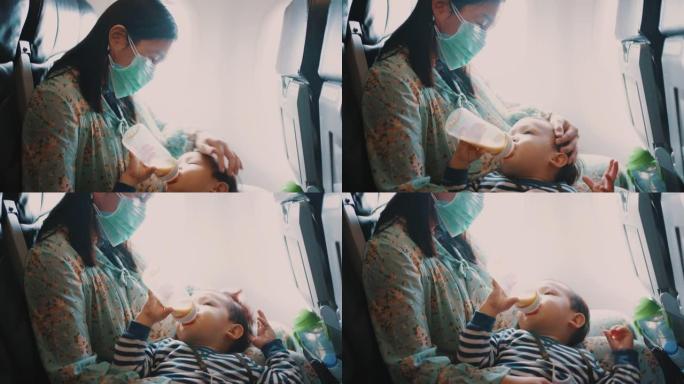 母亲在乘飞机旅行时喂儿子吃饭