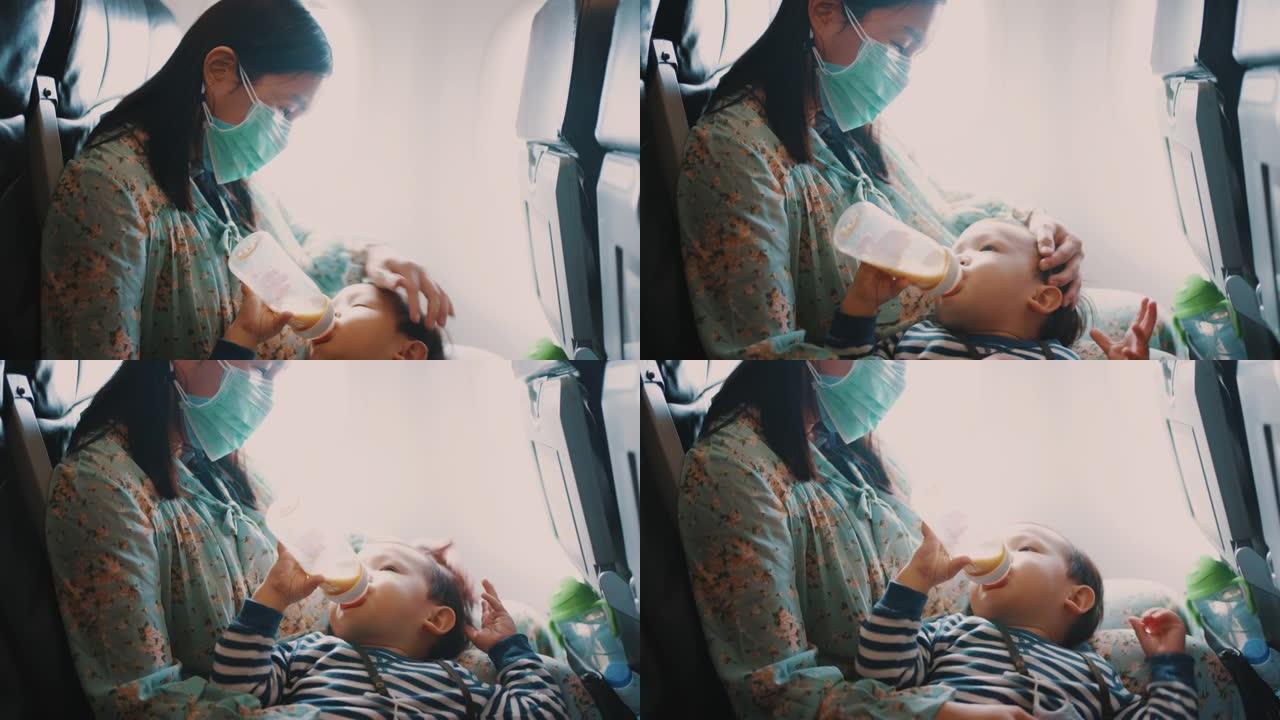 母亲在乘飞机旅行时喂儿子吃饭