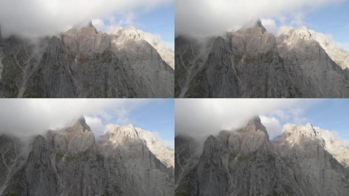 在高耸的山峰和山谷之间飞行的鸟瞰图