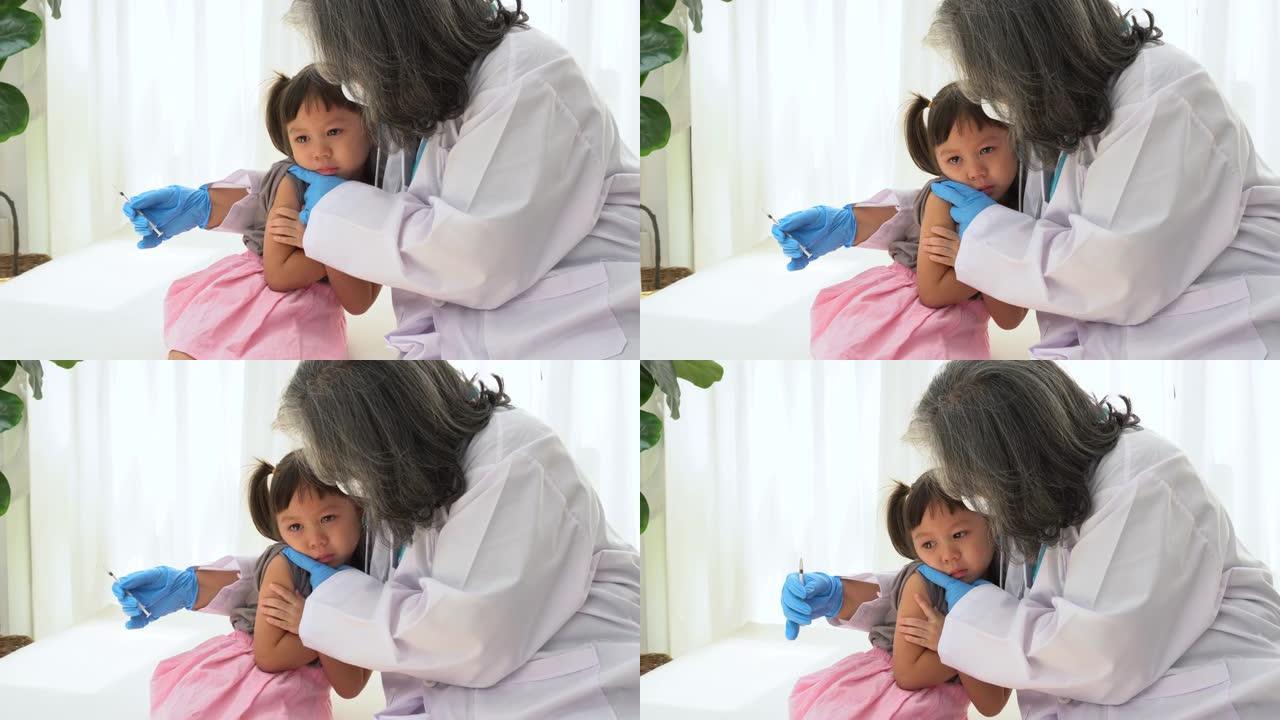 亚洲医生使用注射针注射疫苗，儿童正在接种冠状病毒和流感疫苗。接种免疫的概念